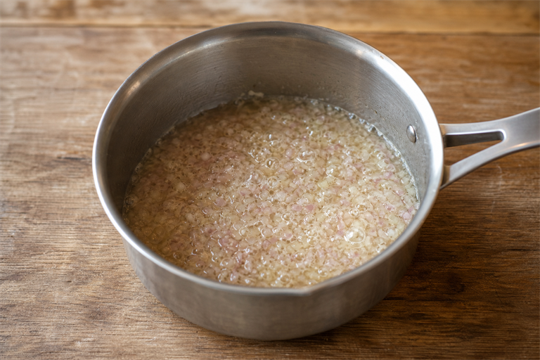 Step 1: finely minced shallots simmering in white wine and vinegar in a small stainless