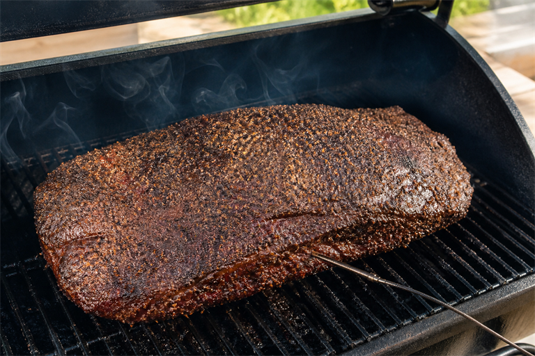 Step 4: a seasoned brisket on the grate of a smoker with thin blue smoke curling, probe 