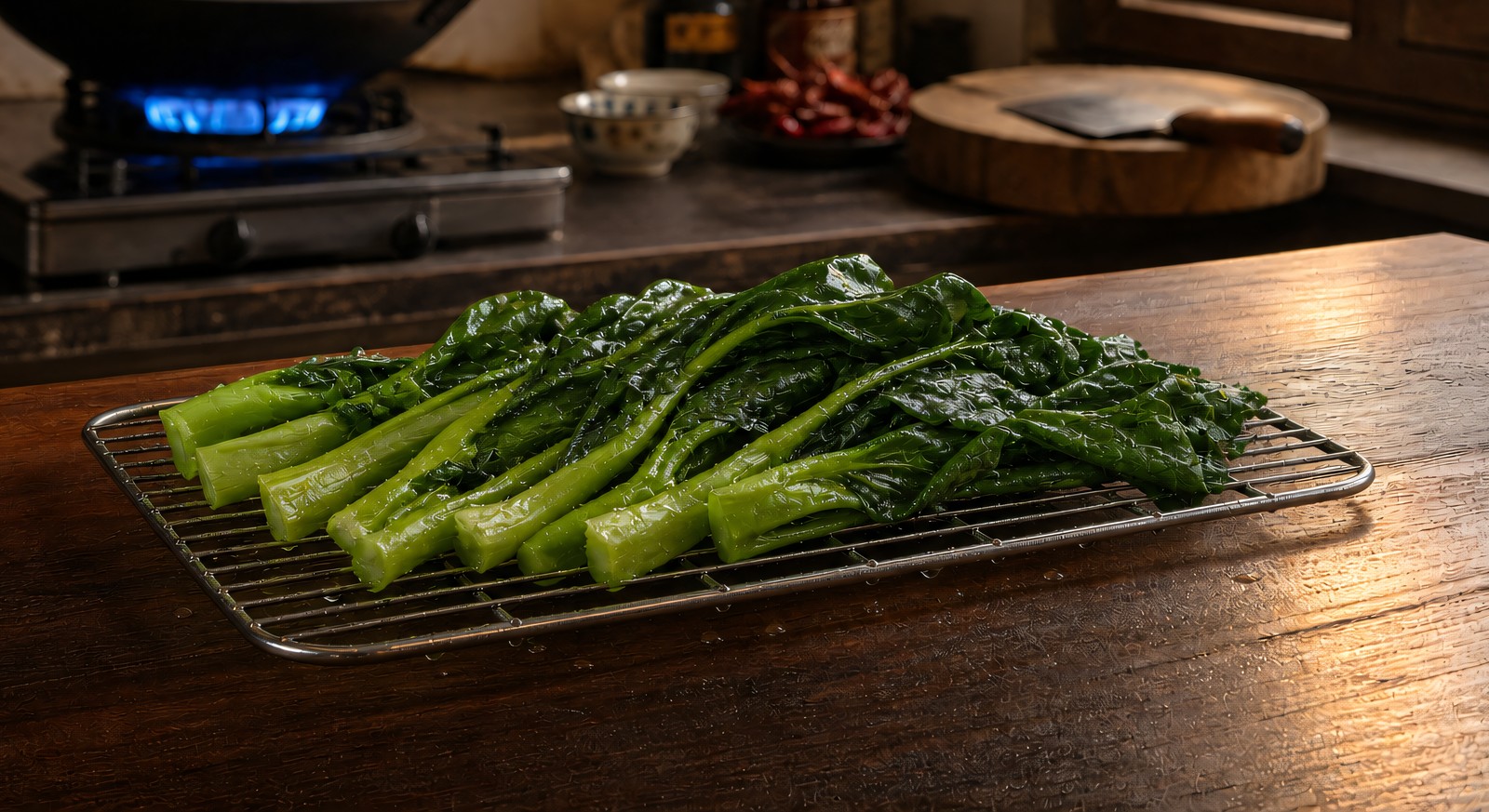 Step 2: split stalks of Chinese broccoli draining on a wire rack, water beading off the 
